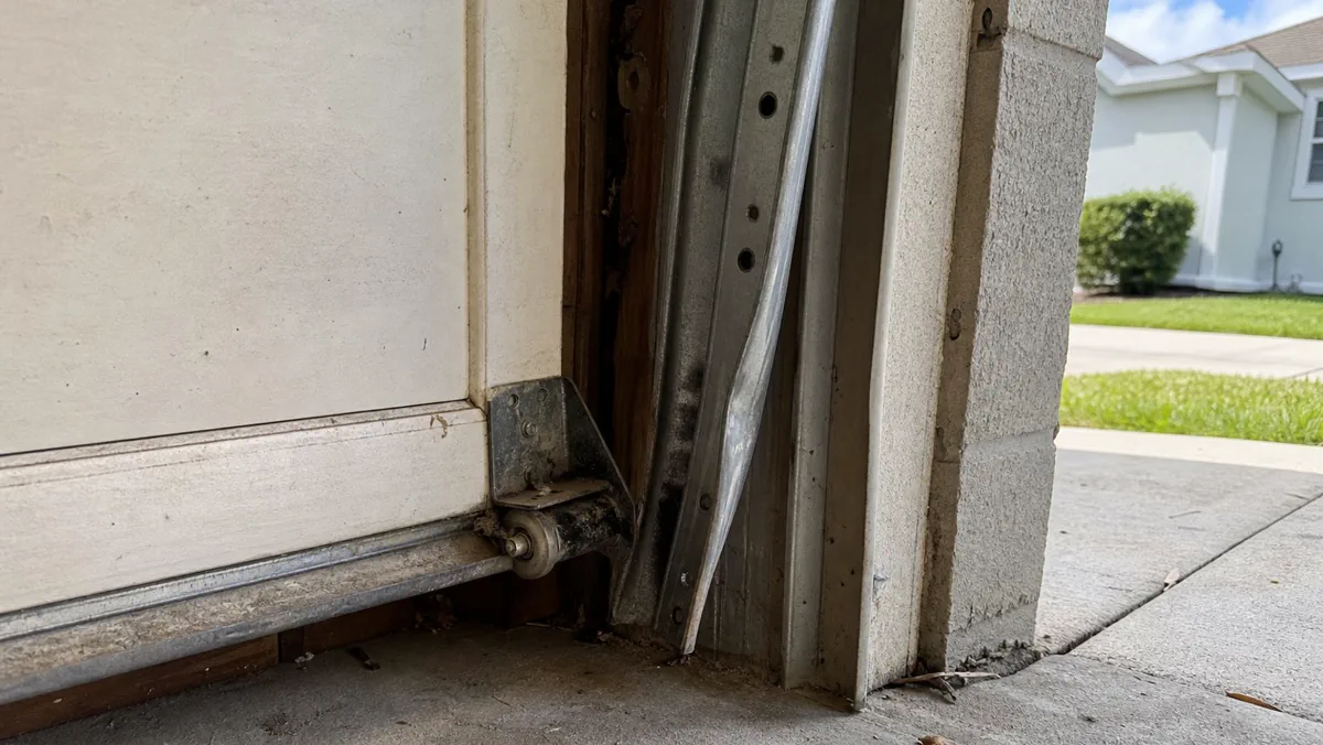 Garage door roller and track closeup during repair in Orlando